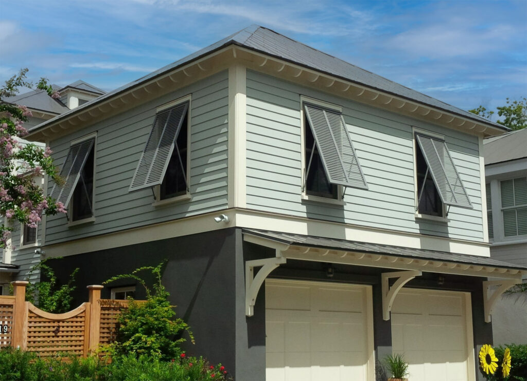 Aluminum bahama hurricane shutters installed on a coastal home.